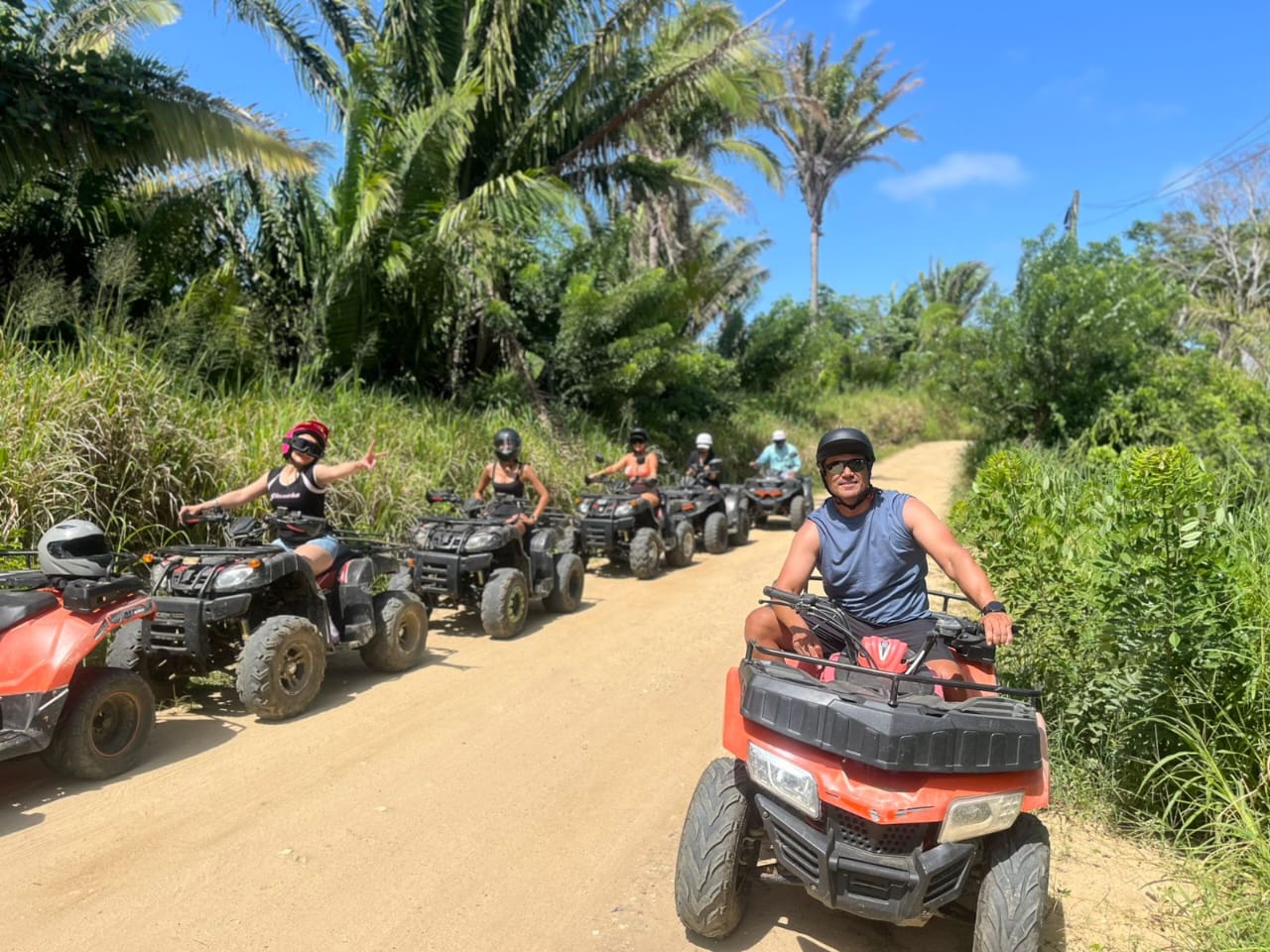 Group riding ATVs on a jungle trail in Roatán